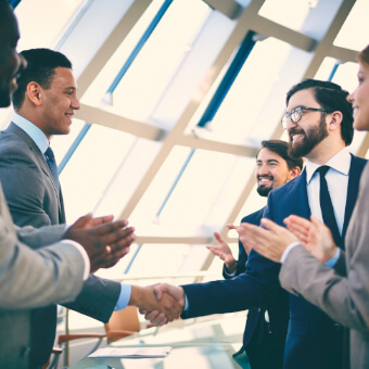 Business partners greet each other after signing the contract